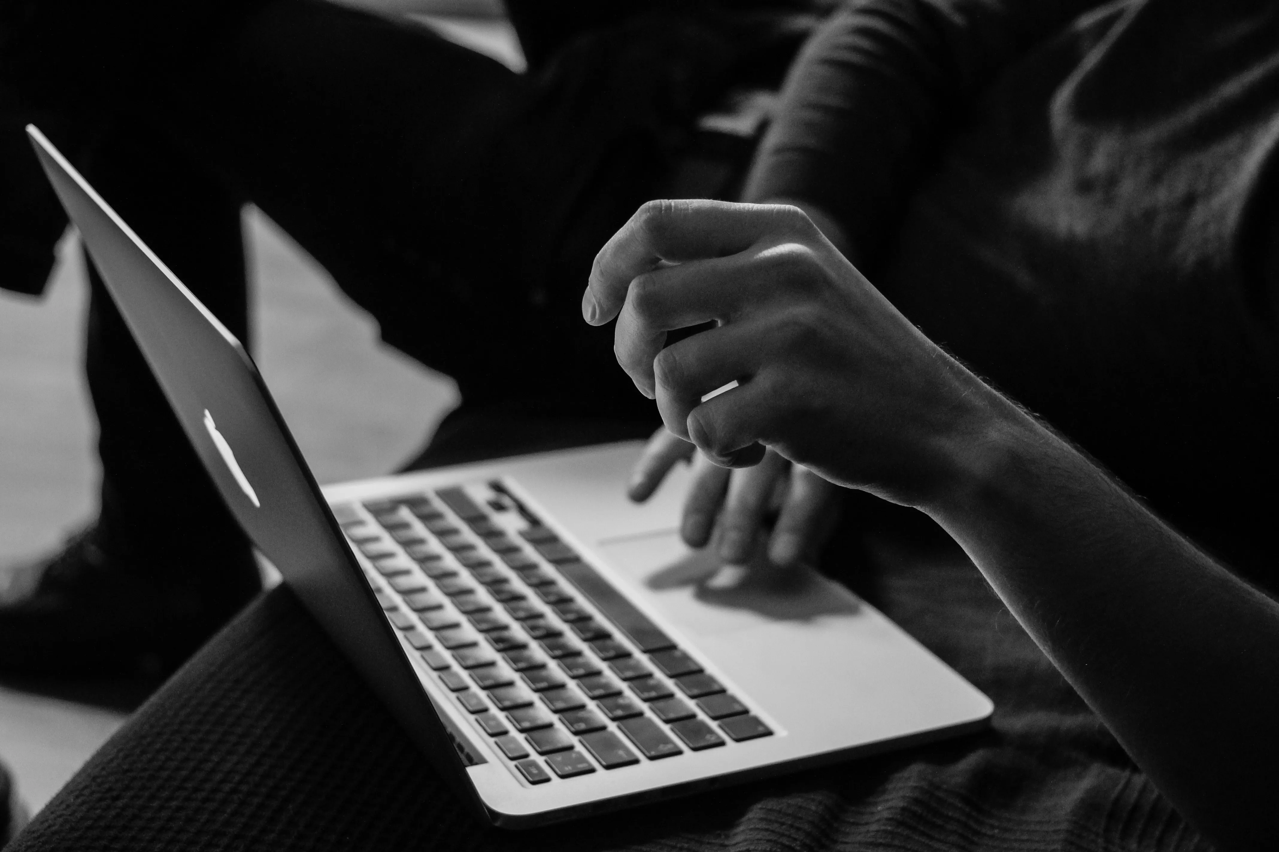 A woman on a mac computer working on a website