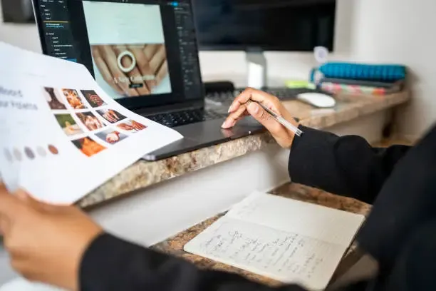 A woman working on a website design in Figma.